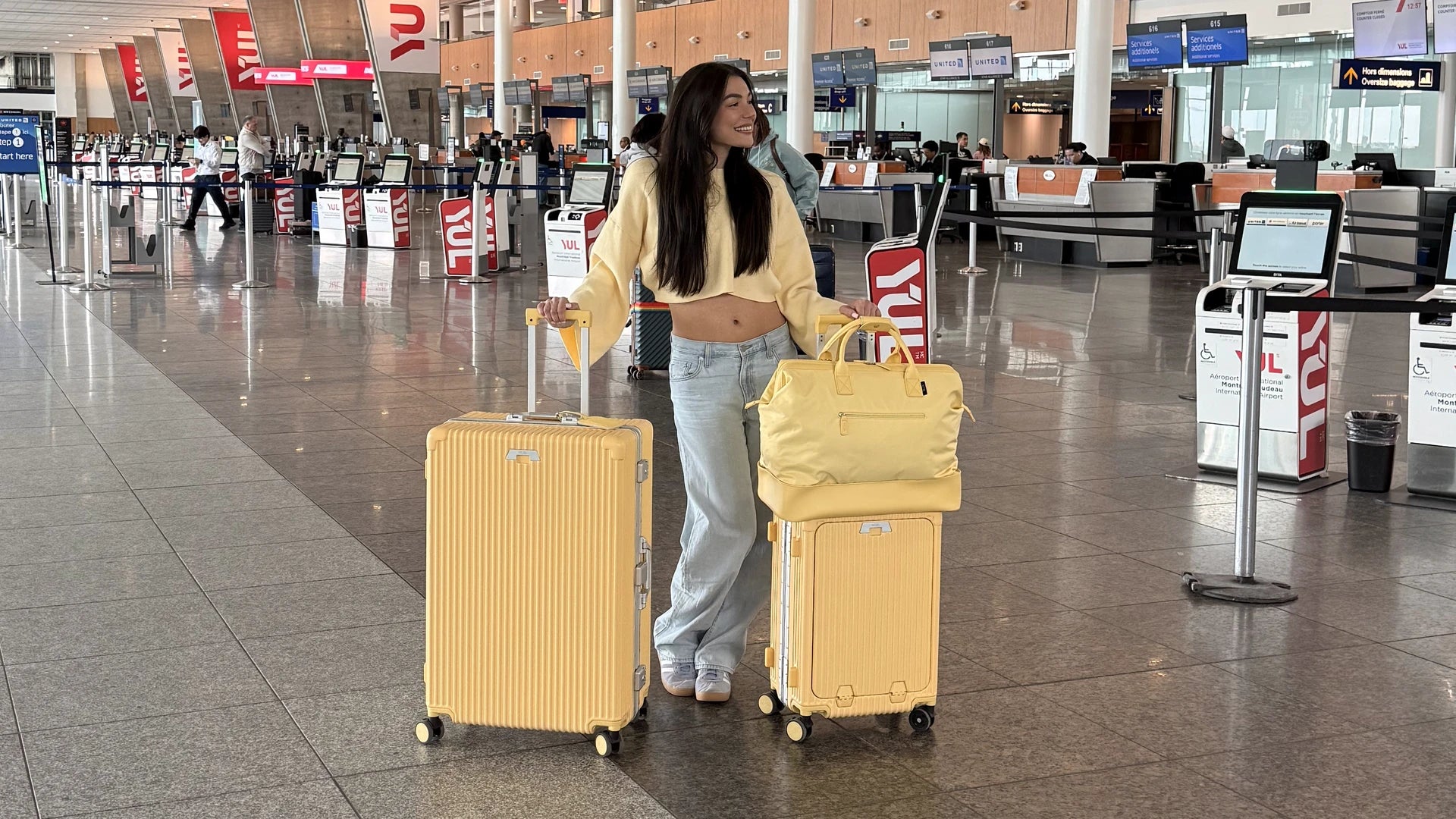 NOBL traveler with Butter Yellow luggage at the airport