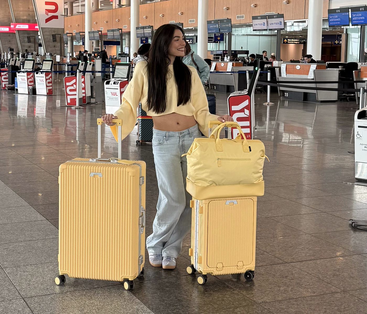 NOBL traveler with Butter Yellow luggage at the airport