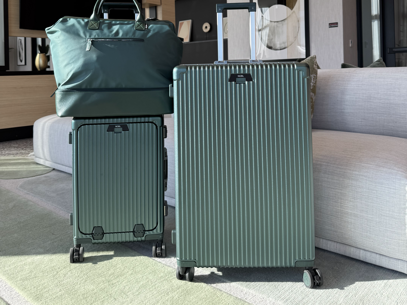 Cup and phone mounted on the NOBL Carry-On handle