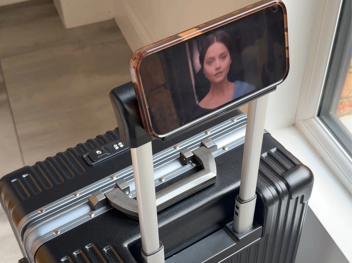 Cup and phone mounted on the NOBL Carry-On handle