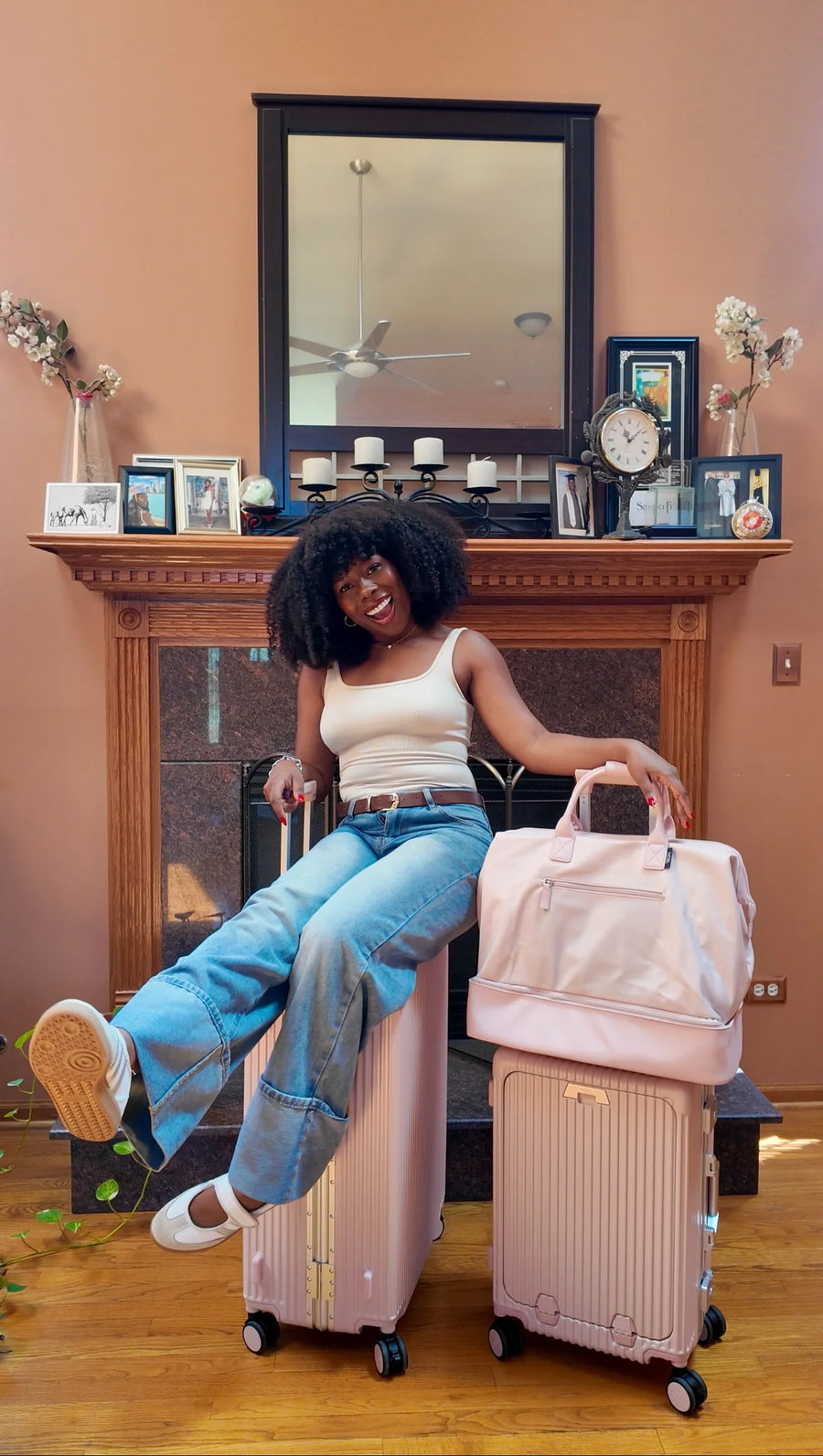Smiling traveler with silver luggage