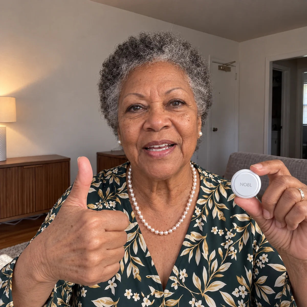 Older Black woman holding NOBL Air™ with a natural smile