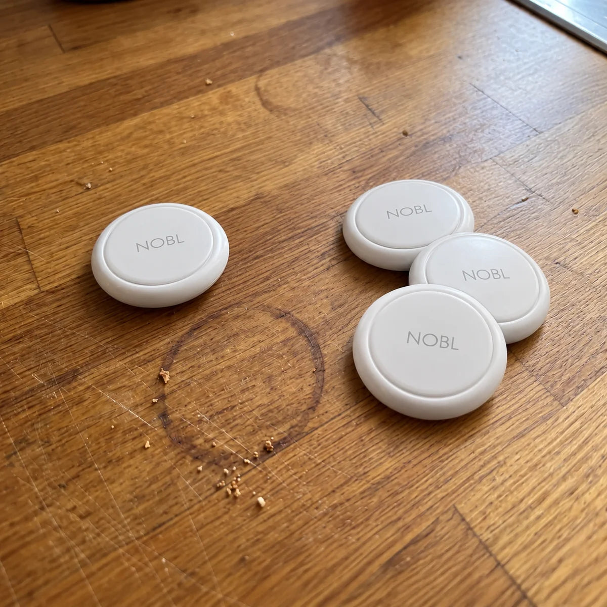White NOBL Air™ trackers on a wooden tabletop