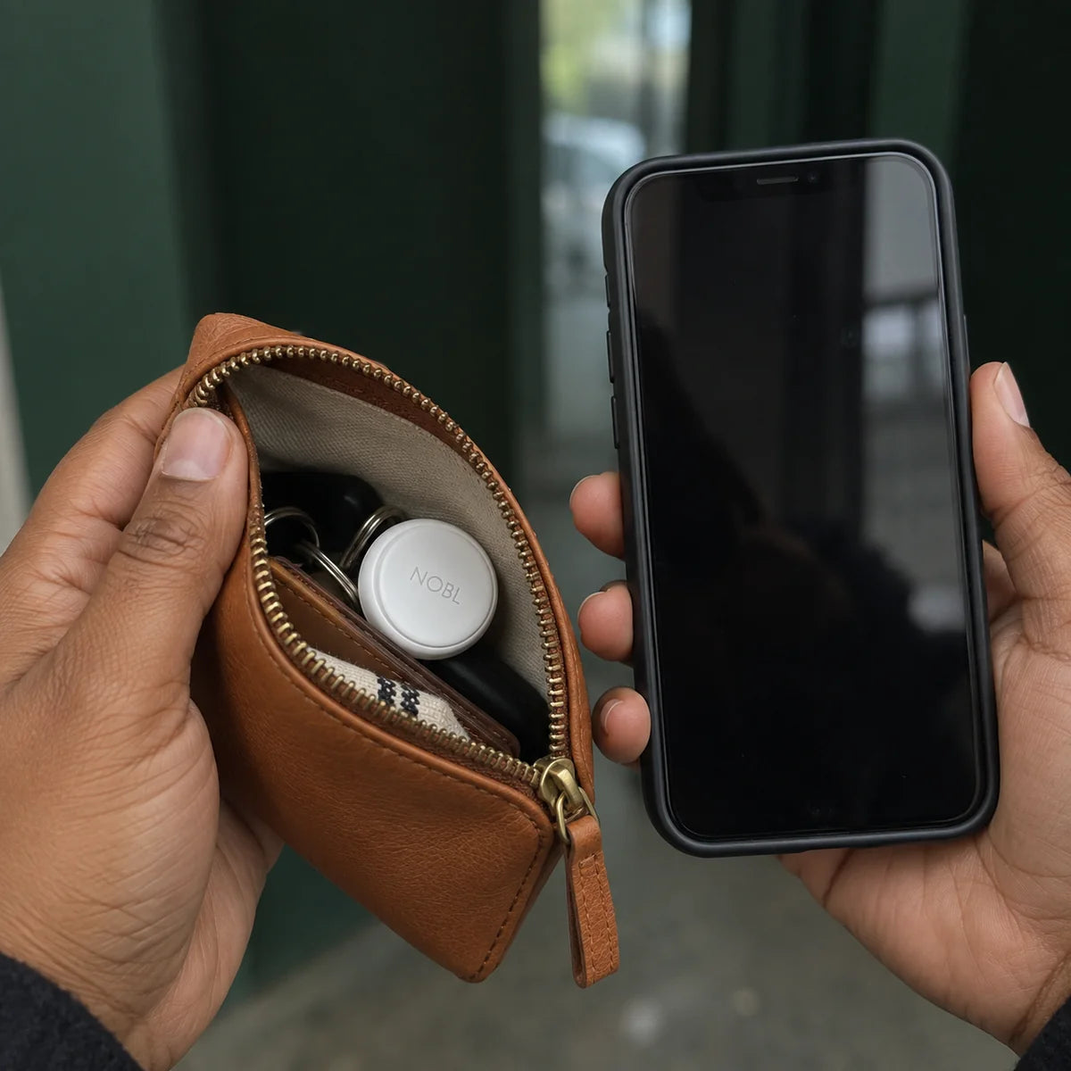 Phone and NOBL Air™ in a brown travel pouch