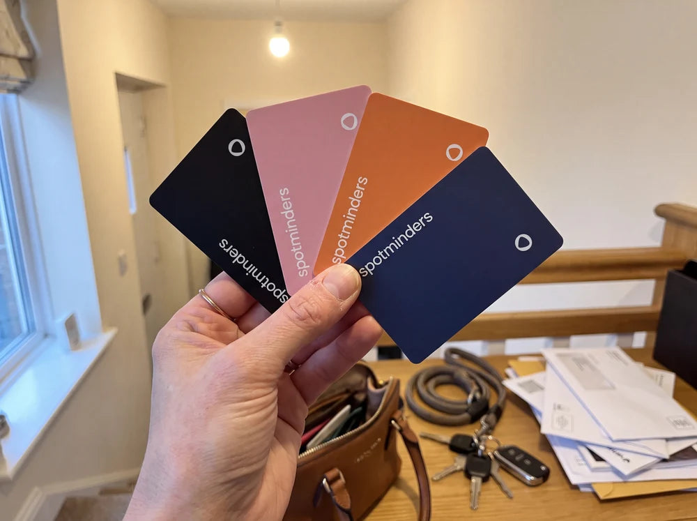Spotminders tracking cards in black, pink, flame orange and harbor navy