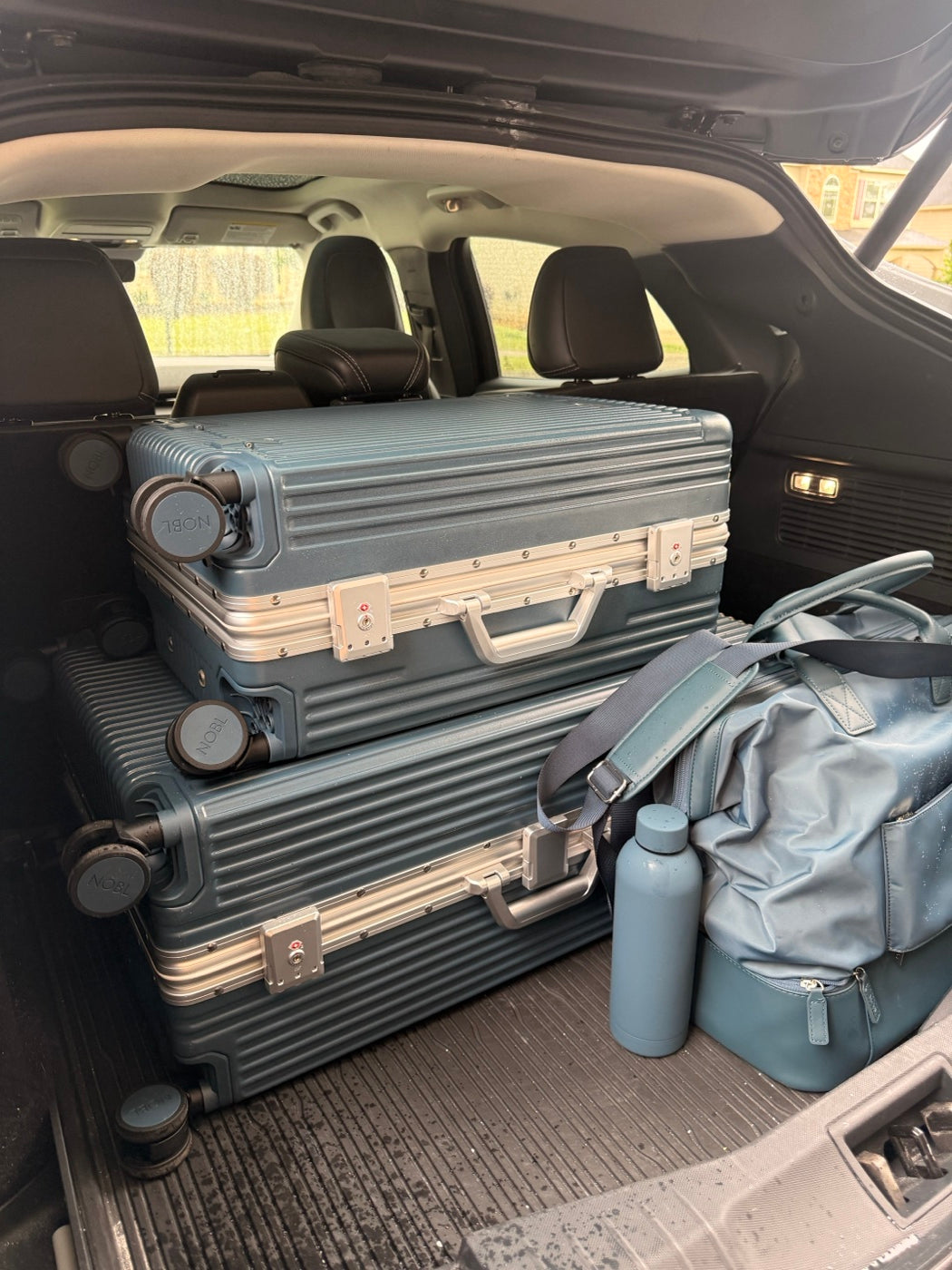 NOBL luggage packed in the trunk